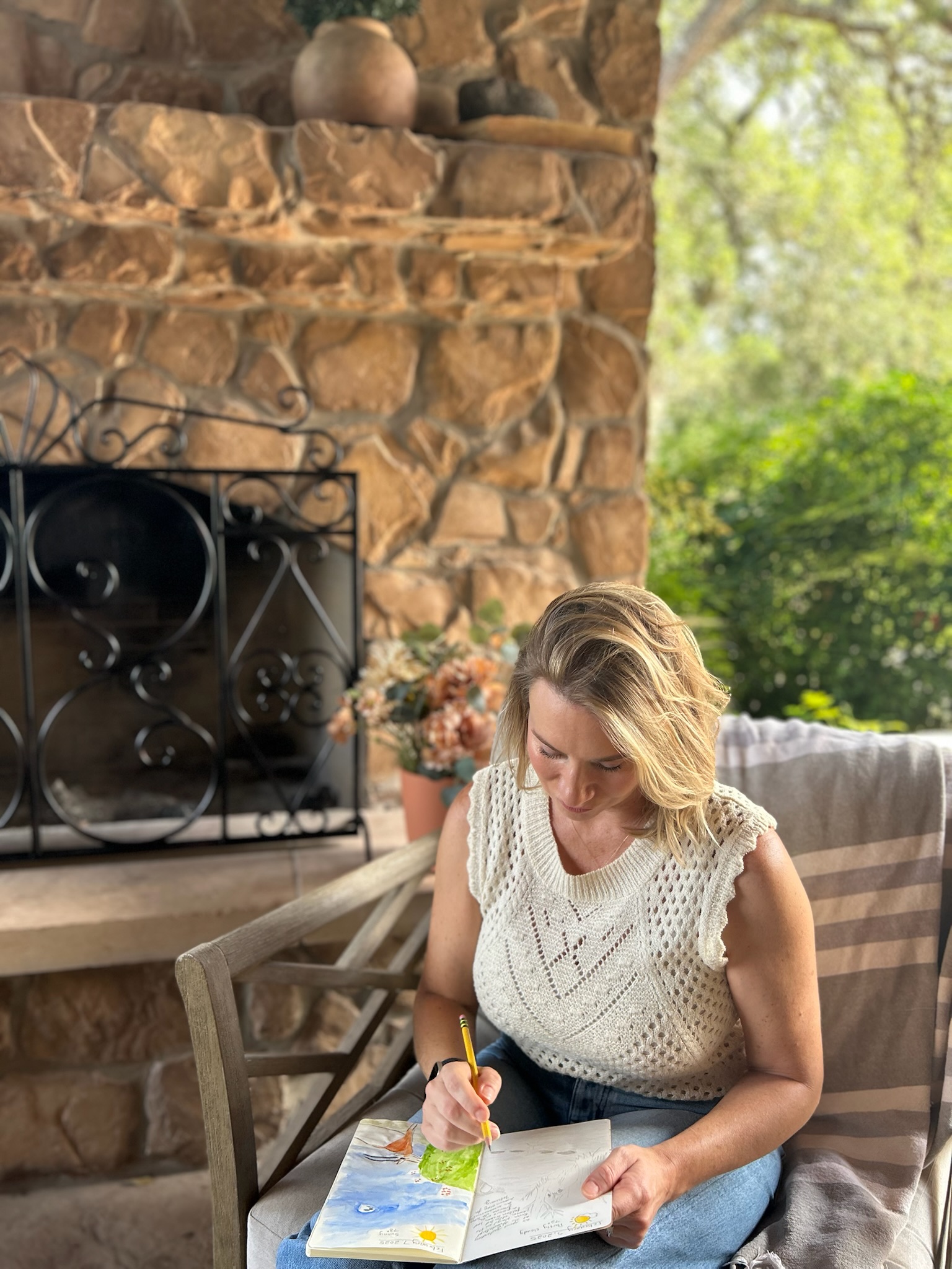 Kim Prieto of Delight & Savor watercolor journaling outdoors on her Texas ranch