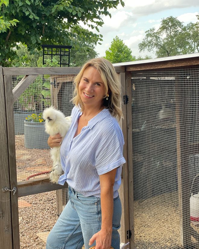 Kim Prieto holding a silkie chicken at the ranch